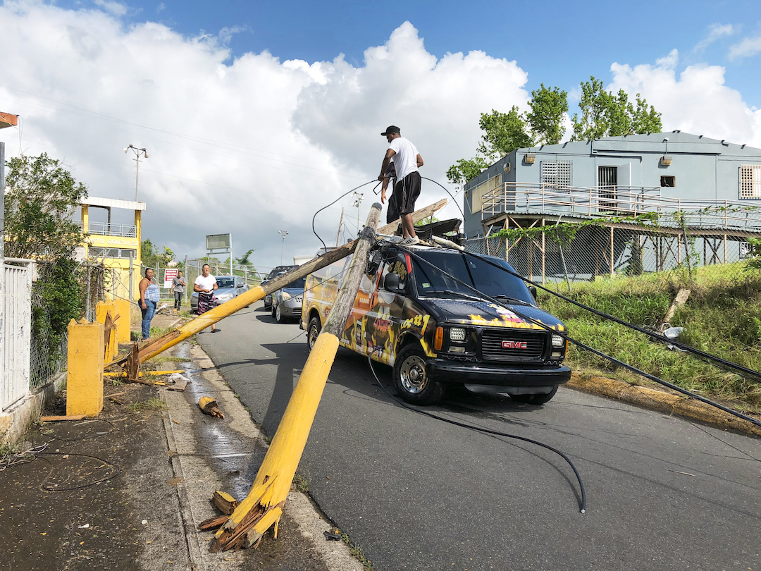 Van with electric pole on top of it in Puerto Rico after Hurricane Maria
