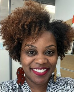 Young African-American female with short curly hair, brown eyes, friendly smile; wearing nice blouse