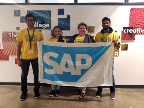 Photo of the app team holding a SAP banner.