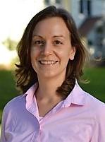 Headshot of Kathleen Sexsmith with long brown hair and pink blouse.