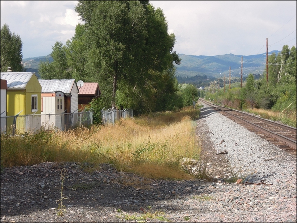 Rural location with trailers and railroad tracks.