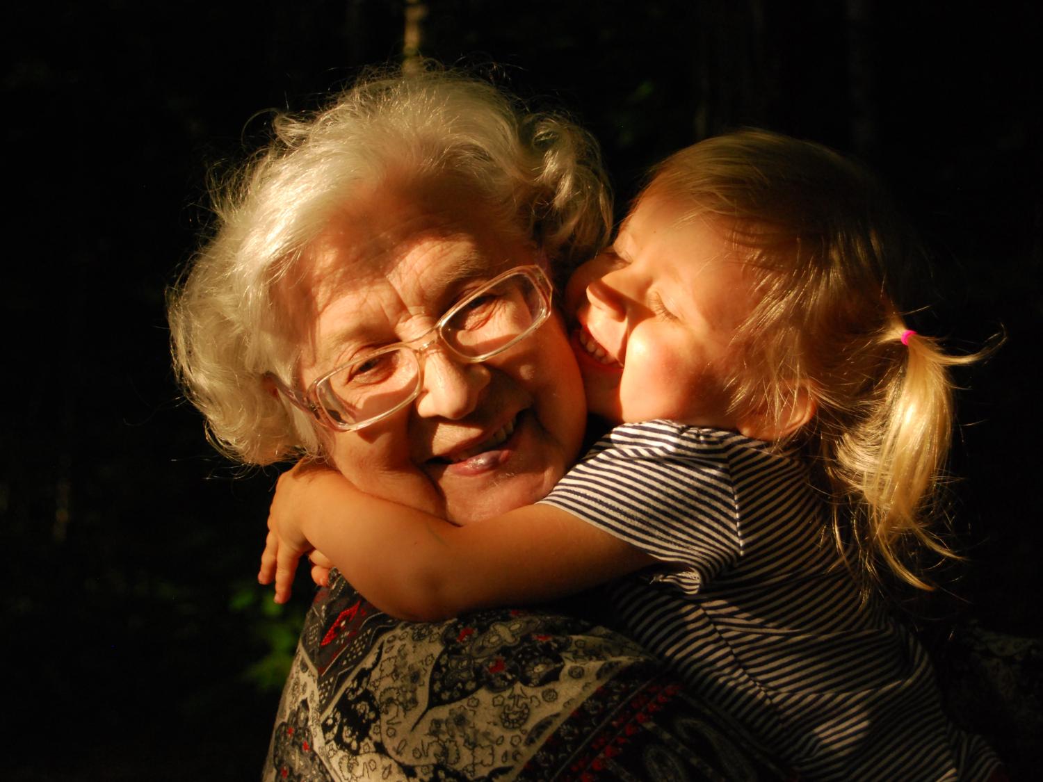 Older woman and child hugging