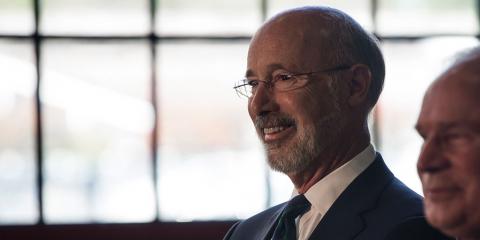 Photo of Pennsylvania Governor Tom Wolf with gray hair, glasses, beard, white shirt, tie, and jacket.