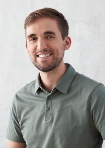 Headshot of Alex Winters, short brown hair, green short sleeved collared shirt.
