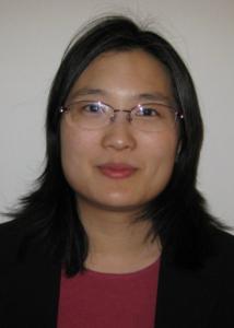 Headshot of Charleen Hsuan with long, dark hair wearing glasses, a pink shirt and black suit jacket. 