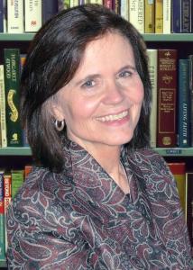 Headshot of Diane Felmlee in a library with mid-length, brown hair wearing a patterned jacket. 