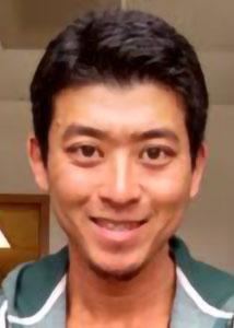 Headshot of Katsuya Oi indoors with brown eyes and short, dark hair wearing a striped top.