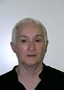 Headshot of Patricia with short white hair and black top.