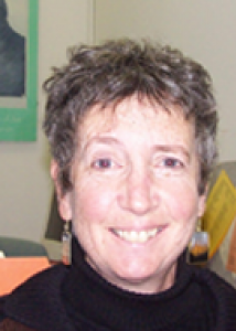 Headshot of Phyllis with short gray hair and black top.