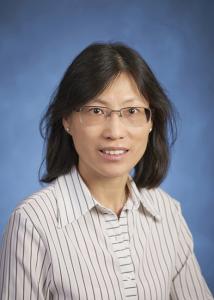 Headshot of Pui-Wa Lei with mid-length, dark hair and glasses wearing striped dress shirt. 