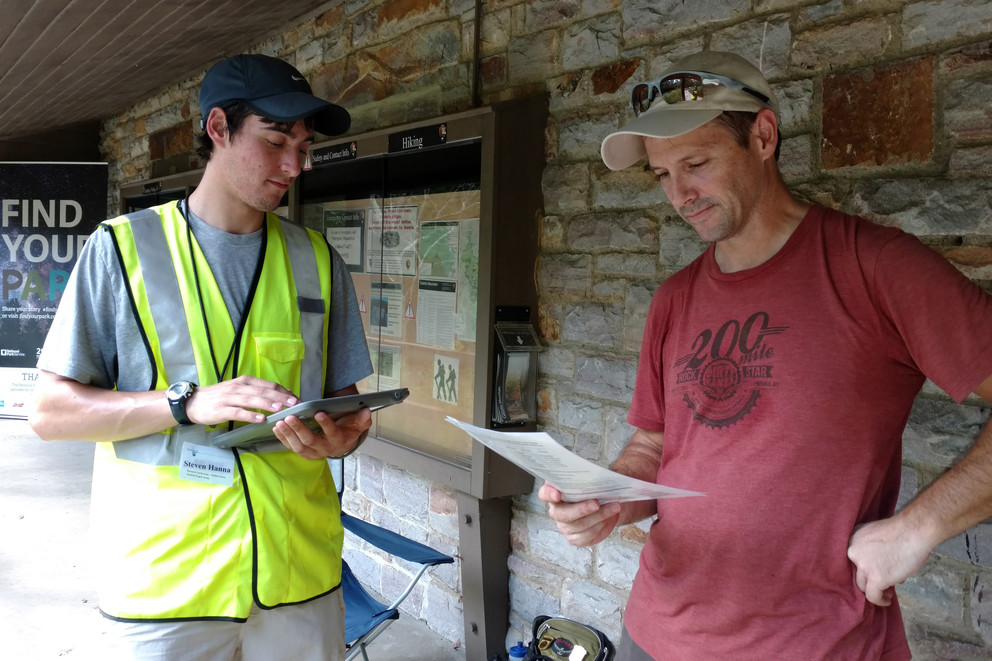 A research team member surveys a park visitor at Catoctin Mountain Park.