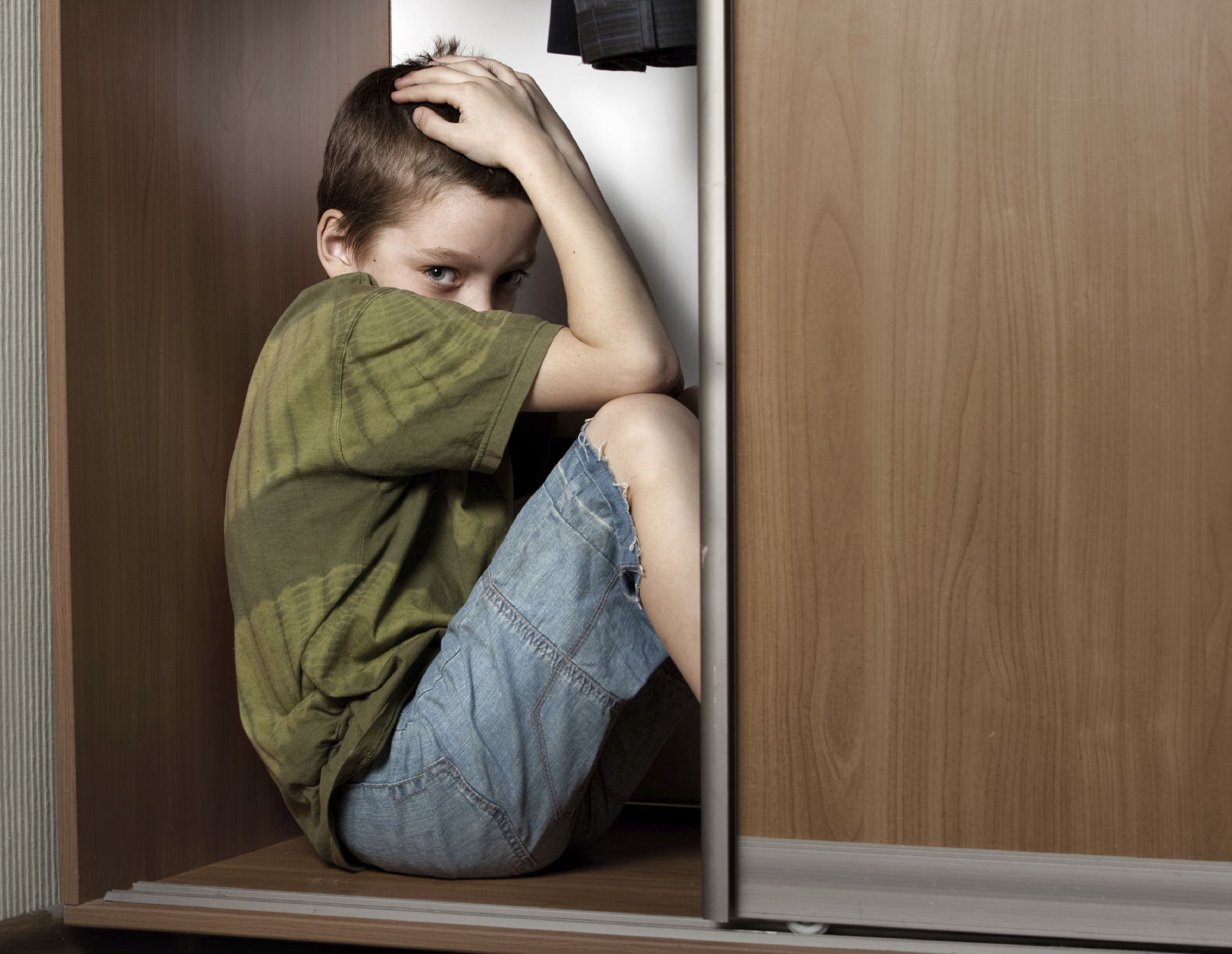 Boy hiding in closet