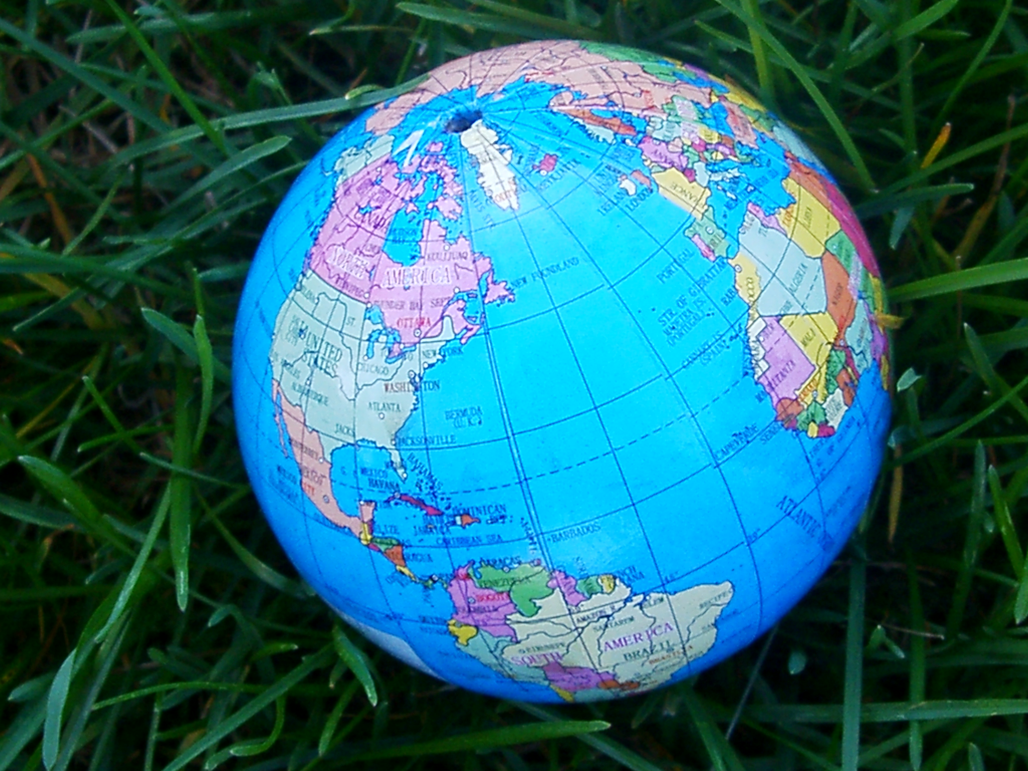 Photo of a globe sitting in the grass.