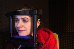 Jessica Yoest, a senior majoring in communication arts and sciences and one of Clara Cohen's research assistants, demonstrates how to use the eye-tracking device.