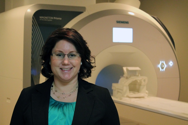 Christina Neely in front of the SLEIC 3T MRI Magnet
