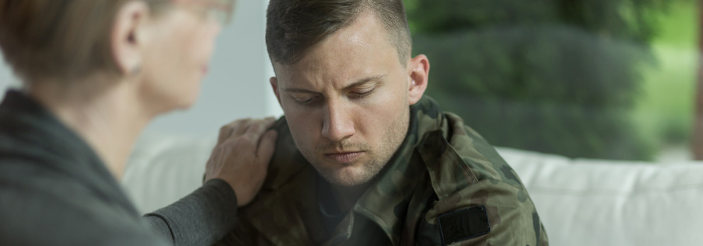Psychologist comforting soldierwith trauma