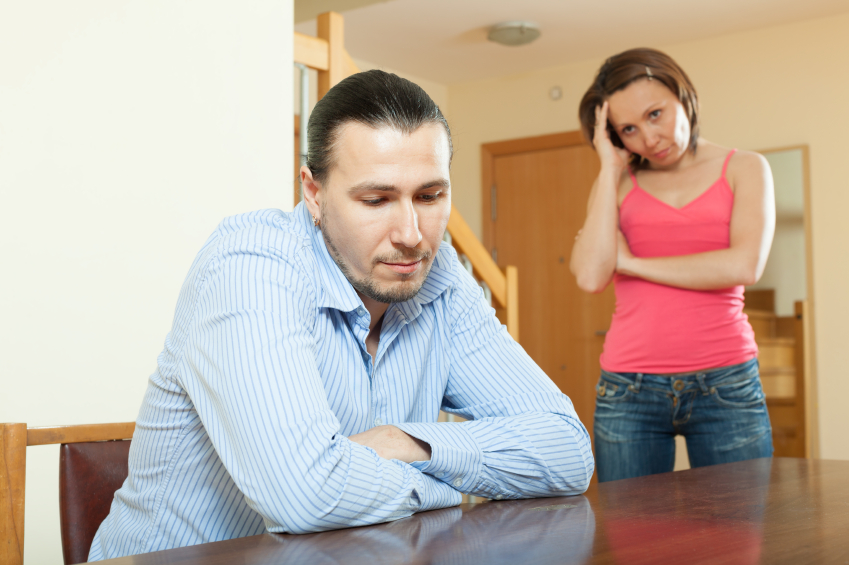 Photo of a man and a woman looking stressed.