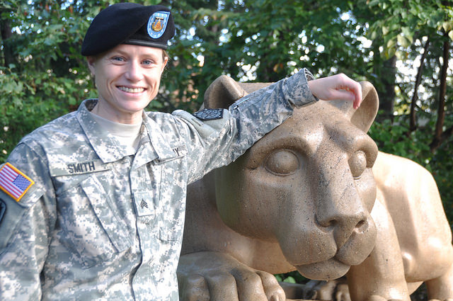 Penn State World Campus student Maggie Smith stands with the Nittany Lion shrine