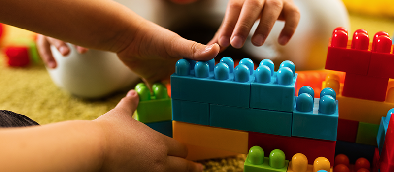 Photo of kids playing with building blocks.