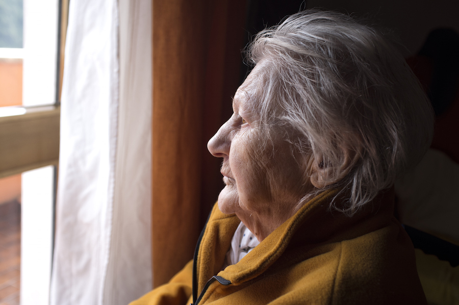 Older woman looking out the window