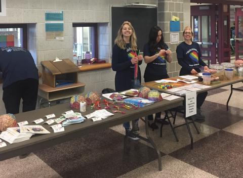 Photo of SLEIC team members standing at tables at Mount Nittany Middle School.