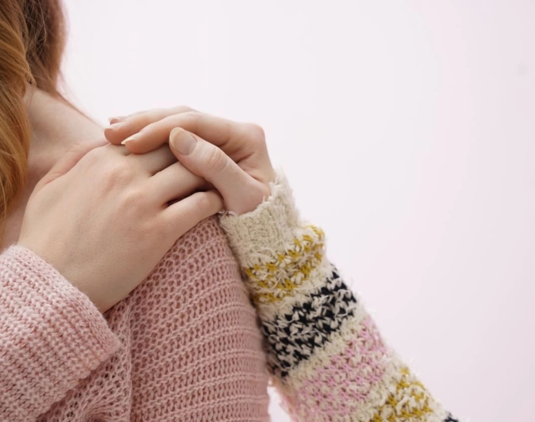 Woman comforting another woman with a hand on her shoulder