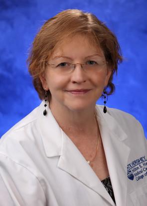 Headshot of Dr. Lori Frasier with short reddish brown hair, glasses, and white coat.