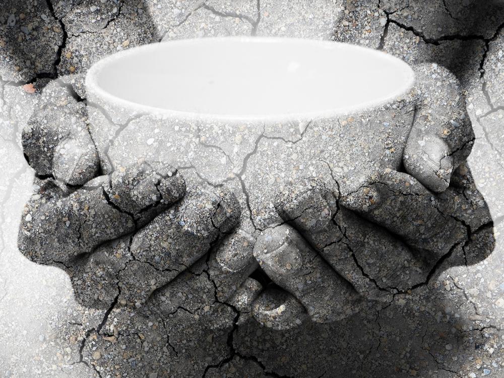 Hands holding empty bowl in black and white.