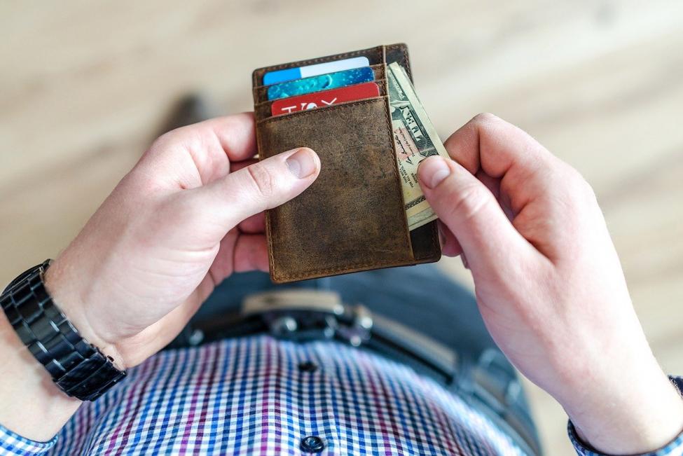 Man holding wallet with money
