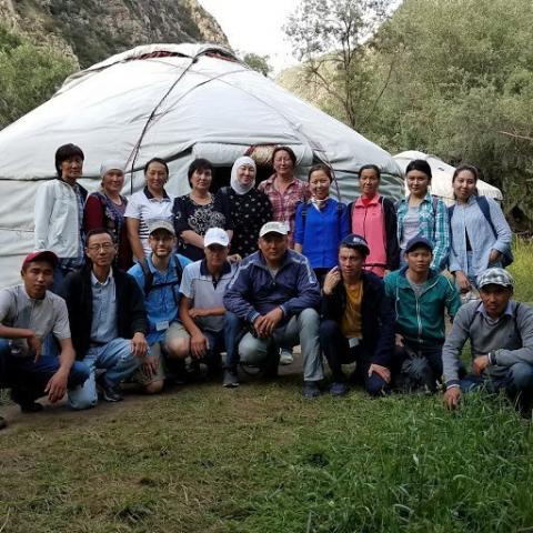 Photo of researchers, data collectors and translators in Alay Rayon, Osh standing in front of a tent. Oblast