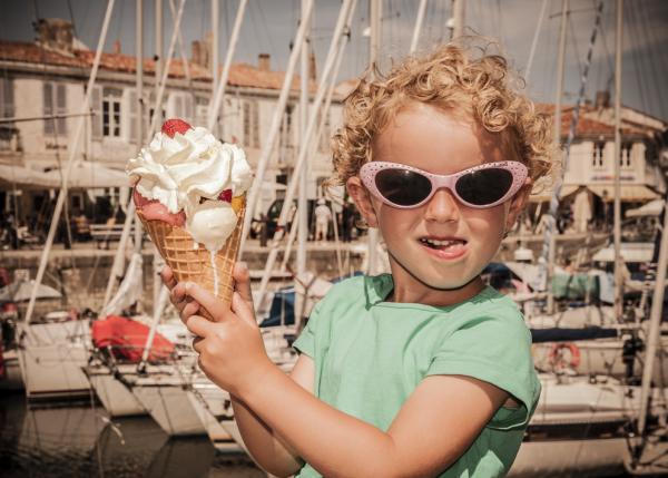 Child holding big ice cream cone