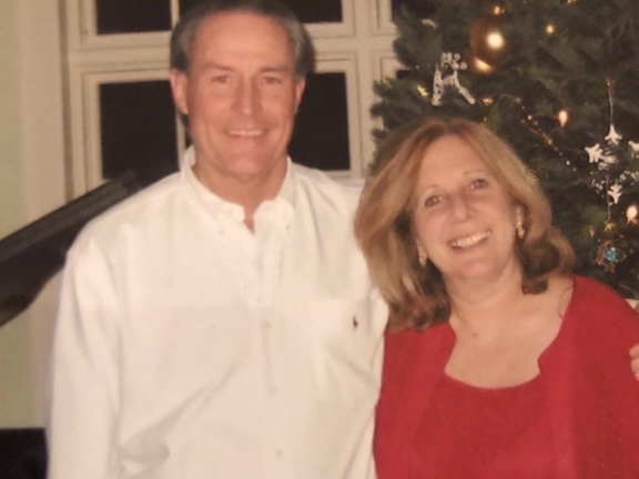 Bob and Denise Rohrbach in front of Christmas tree