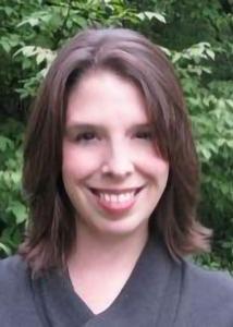 Sarah Damaske head shot in black shirt, medium-length brown hair.