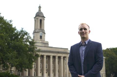 Scott Graupensperger standing in front of the Old Main Building on the University Park campus.