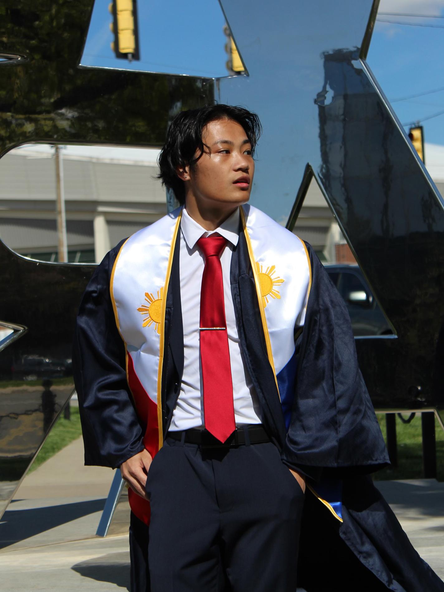 Austin Lee in suit, tie, and graduation gown