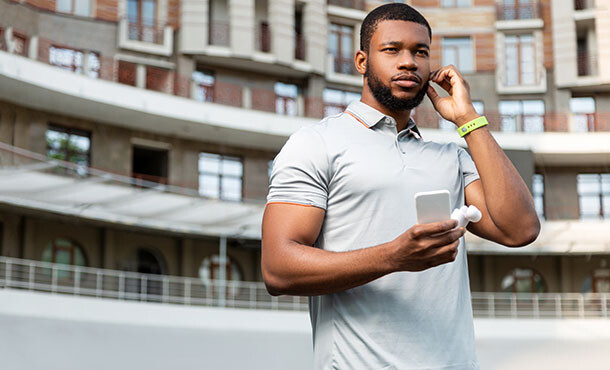 Man checking fitness tracker via cellphone