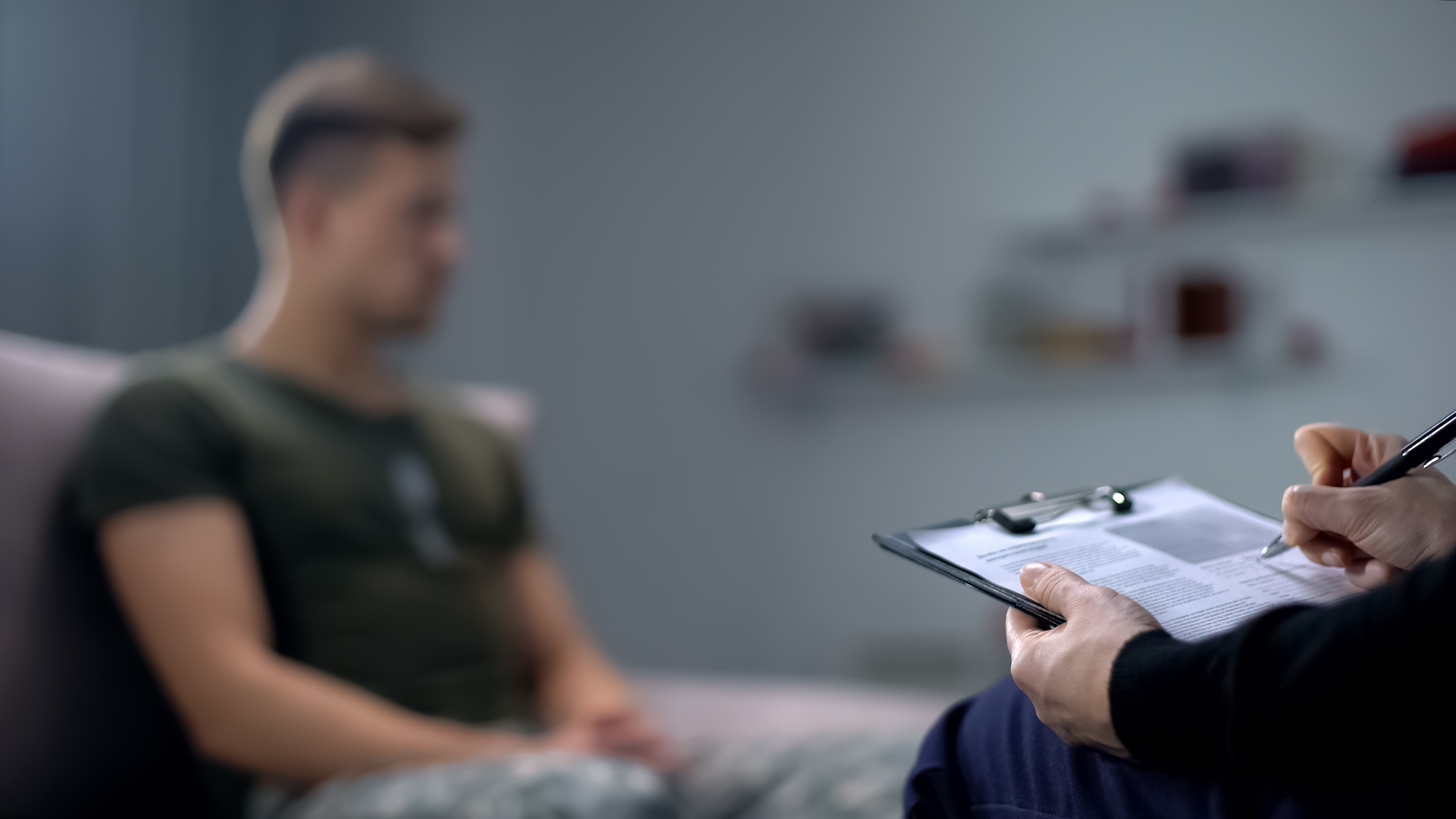 Service member speaking to psychologist