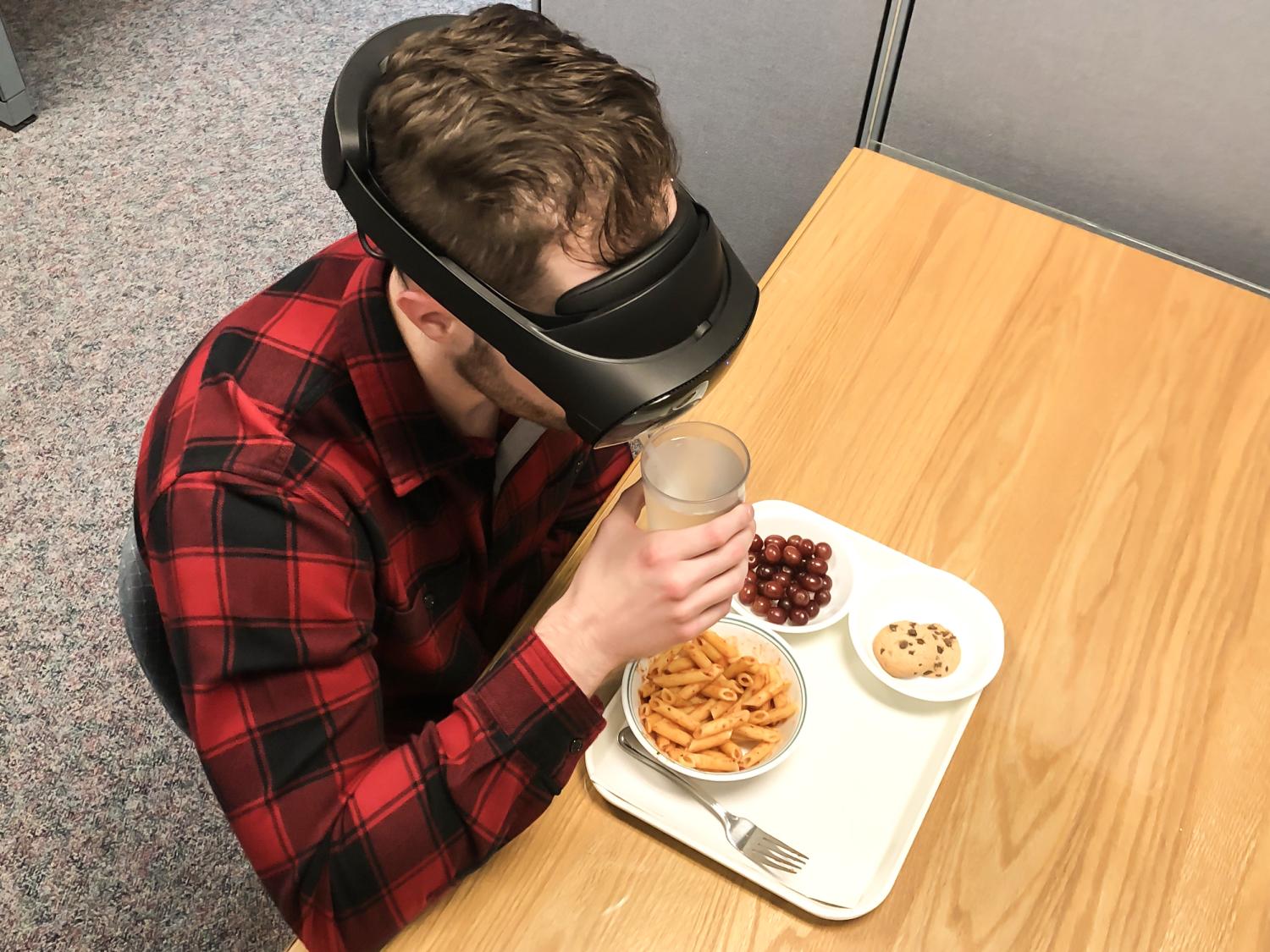 Young male eating in virtual lab