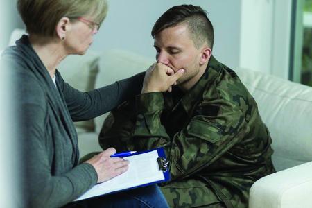 Photo of a depressed soldier with a psychologist.