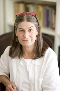 Photo of Lisa Berkman with long brownish gray hair and white blouse.