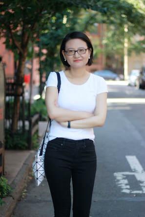 Cheng with dark hair, glasses and white shirt