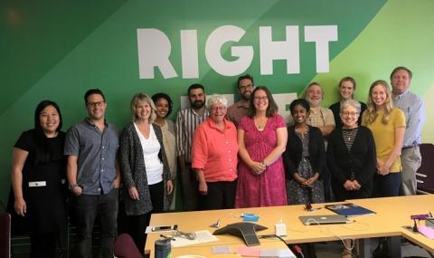 Photo of the collaborators standing against a green wall with the word "Right" painted above them.