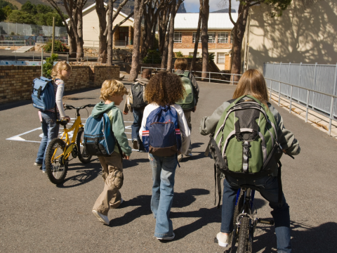 Kids walking and riding their bikes to school.