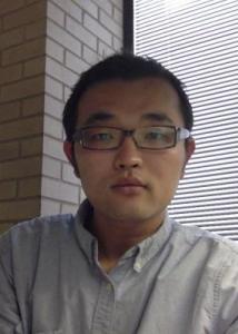 Headshot of Junjun Yin with short black hair, thick glasses and a light blue shirt.