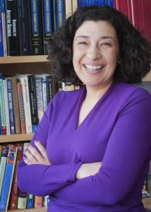 Headshot of Koraly Pérez-Edgar with black hair and purple long sleeved blouse.
