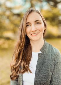 Headshot of Lindy Williams with long golden hair in gray sweater.