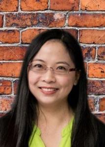 Headshot of Linying Ji with long black hair in black sweater with glasses.