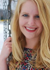 Headshot of Lizbeth Benson with long blonde hair and multi-colored floral top.