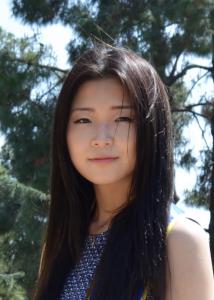 Headshot of Sharon Kim with long straight black hair in blue dress.