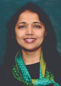 Headshot of Triparna Vasavada, a woman with long, dark hair wearing a black shirt and green scarf.